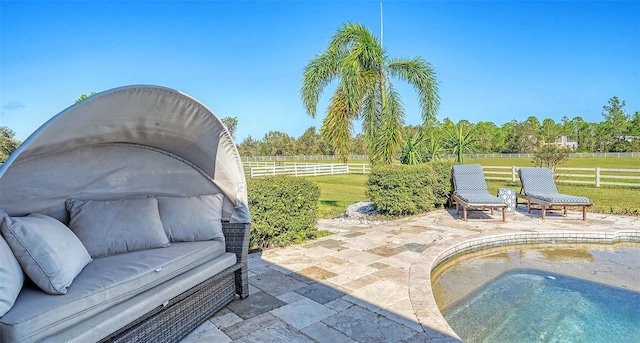 view of patio / terrace with a rural view and a jacuzzi