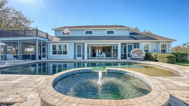 rear view of property featuring a patio area and a balcony