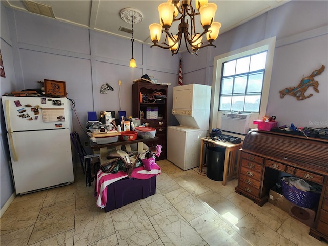 dining space with stacked washing maching and dryer, cooling unit, and a chandelier