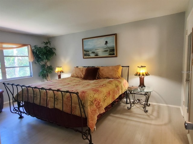 bedroom with hardwood / wood-style floors