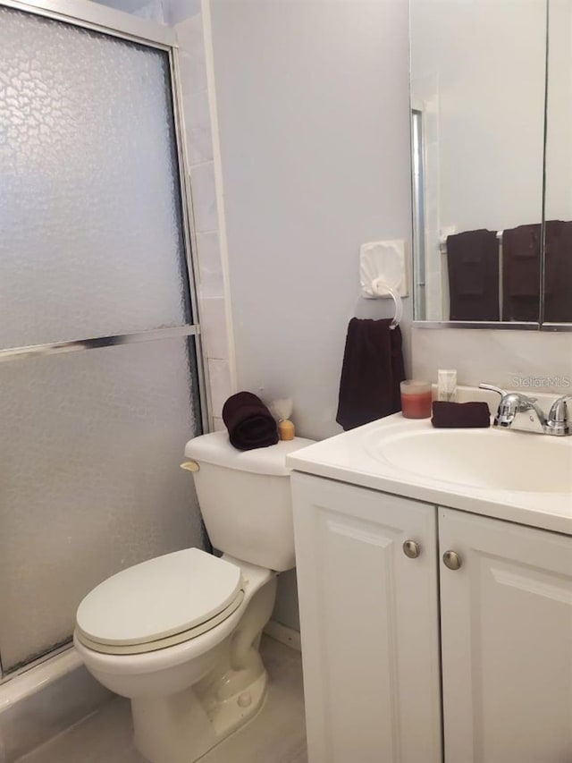 bathroom with vanity, walk in shower, and toilet