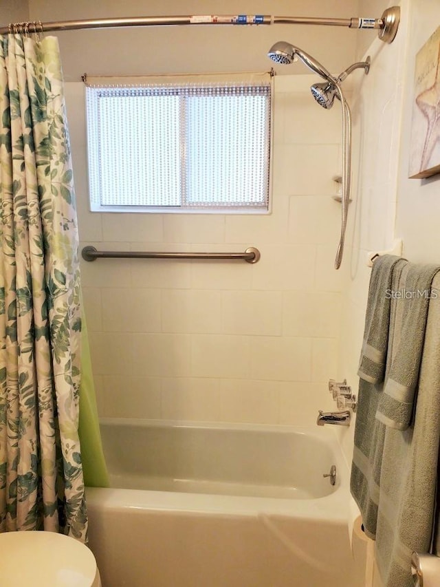 bathroom with shower / tub combo and toilet