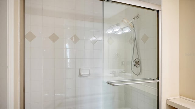 bathroom featuring a shower with door