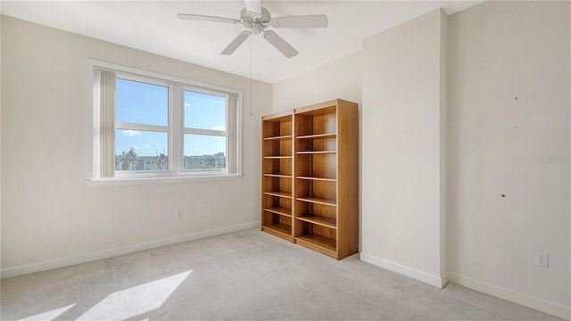 carpeted empty room with ceiling fan