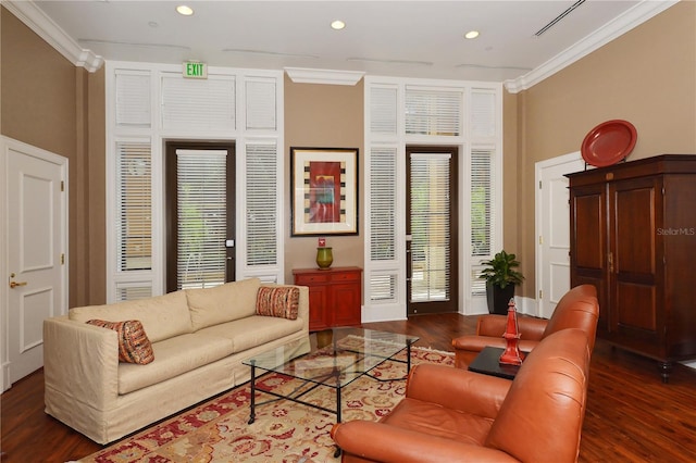 living room with crown molding, dark hardwood / wood-style flooring, and a wealth of natural light