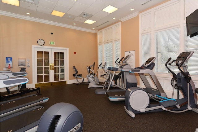 gym with french doors, a paneled ceiling, and crown molding