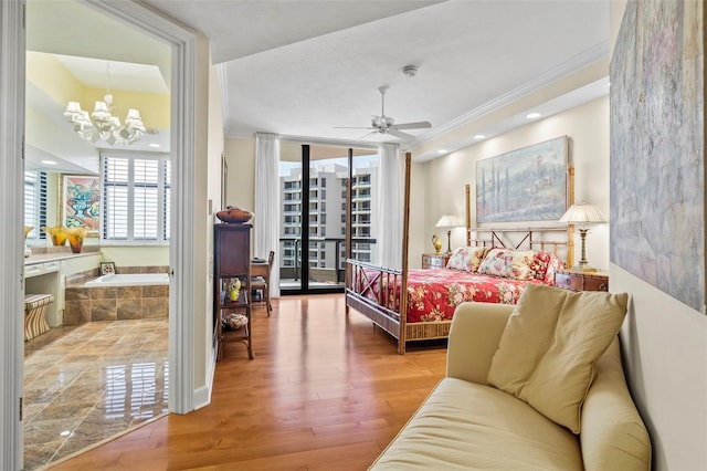 bedroom featuring ornamental molding, wood-type flooring, and a chandelier