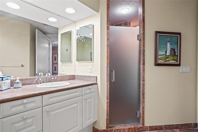 bathroom with vanity and a shower with shower door