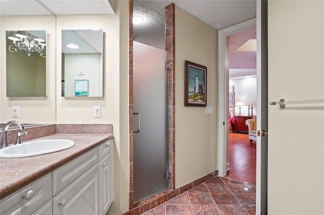 bathroom with walk in shower and vanity