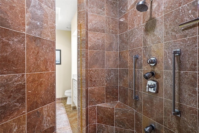 bathroom featuring tiled shower and toilet