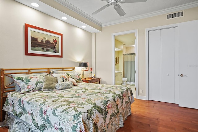 bedroom featuring ensuite bath, ceiling fan, hardwood / wood-style floors, ornamental molding, and a closet