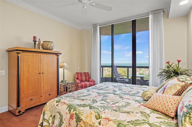 bedroom featuring crown molding, ceiling fan, access to exterior, hardwood / wood-style floors, and floor to ceiling windows