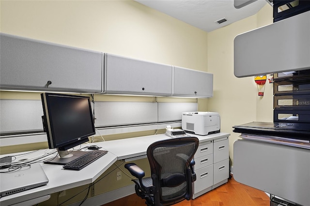 office area with built in desk and light hardwood / wood-style flooring