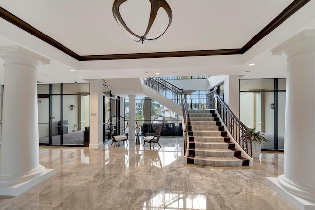 stairs featuring decorative columns and ornamental molding