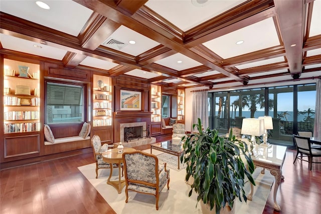 living room featuring coffered ceiling, hardwood / wood-style flooring, and a high end fireplace