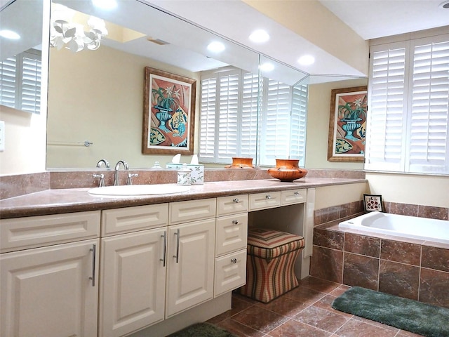 bathroom featuring vanity and tiled bath