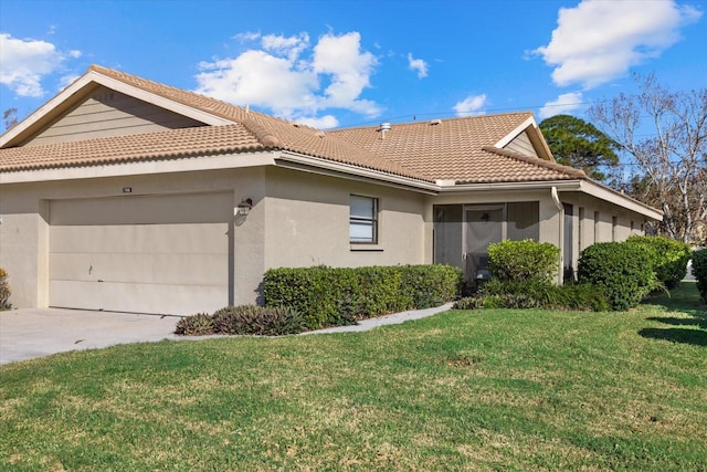 view of side of home featuring a garage and a lawn