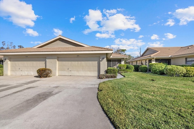 ranch-style house featuring a garage and a front yard