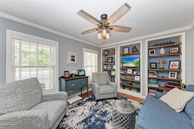 sitting room featuring crown molding, a textured ceiling, wood-type flooring, and ceiling fan