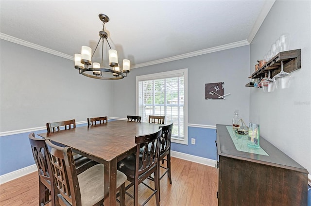 dining space featuring an inviting chandelier, crown molding, and light wood-type flooring