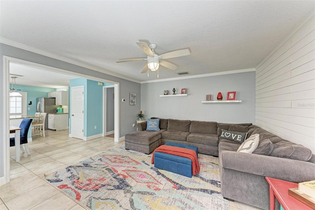 living room featuring ceiling fan, a textured ceiling, and ornamental molding