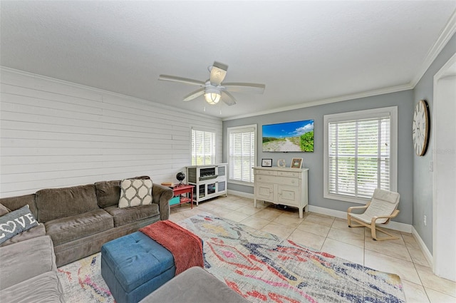 living room with ornamental molding, light tile patterned floors, and ceiling fan