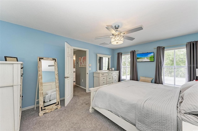 bedroom featuring ceiling fan and light colored carpet