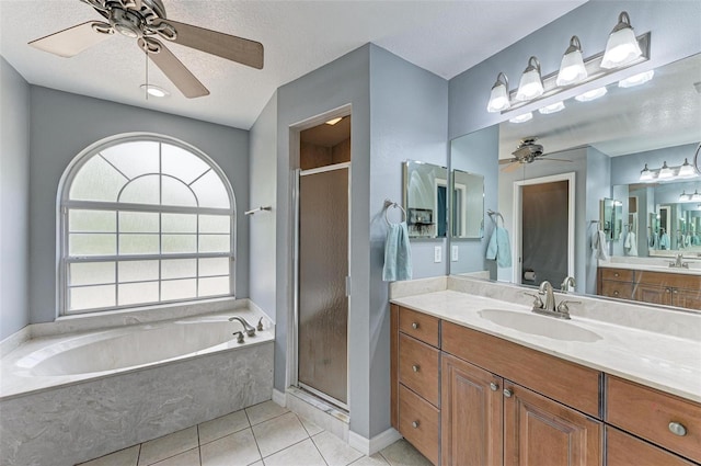 bathroom with vanity, a textured ceiling, tile patterned flooring, and plus walk in shower