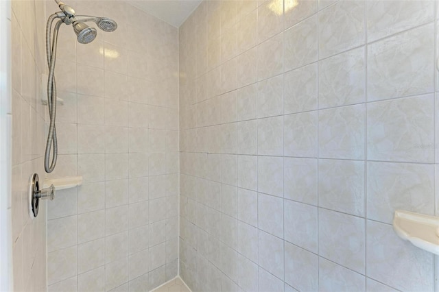 bathroom with a tile shower