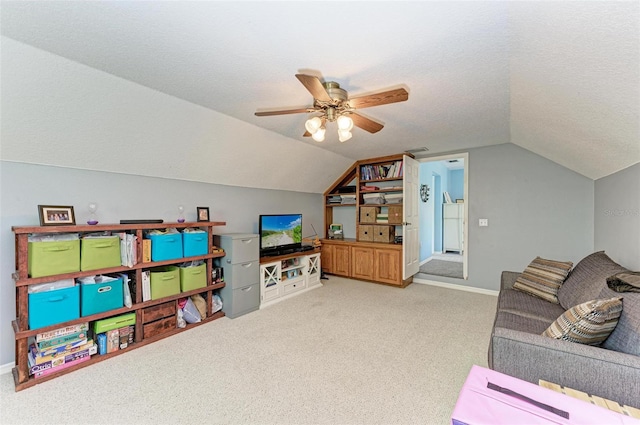 rec room with a textured ceiling, vaulted ceiling, carpet floors, and ceiling fan