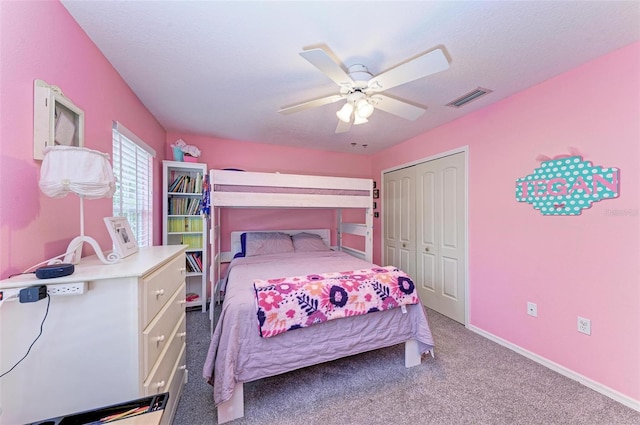 bedroom with a closet, light colored carpet, and ceiling fan