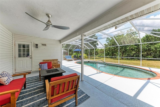 view of swimming pool with a patio, glass enclosure, and ceiling fan