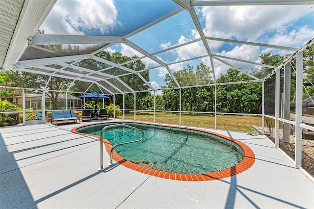 view of pool with a yard, a patio area, and a lanai