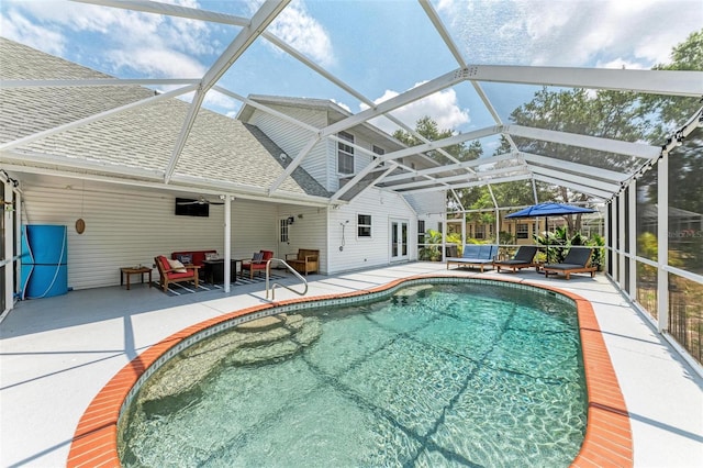 view of swimming pool featuring a patio area, glass enclosure, and ceiling fan