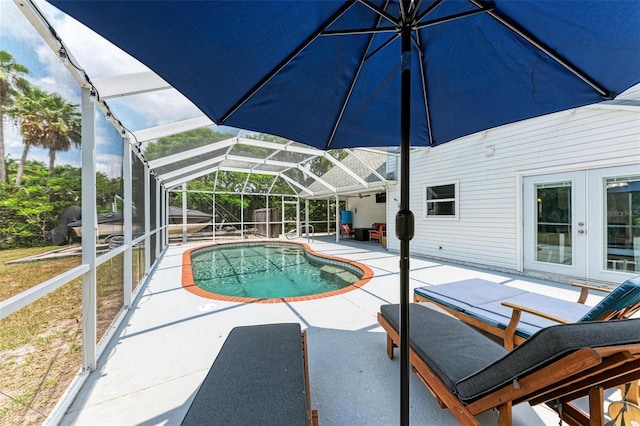 view of swimming pool featuring a patio and a lanai