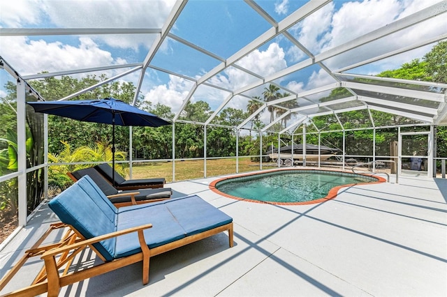 view of swimming pool featuring a patio area and a lanai