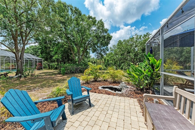 view of patio / terrace featuring glass enclosure