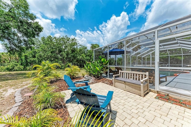 view of patio / terrace featuring glass enclosure