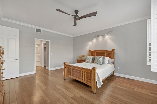 bedroom with ceiling fan, light hardwood / wood-style floors, and crown molding