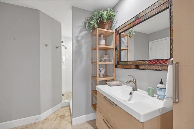 bathroom with vanity and a shower