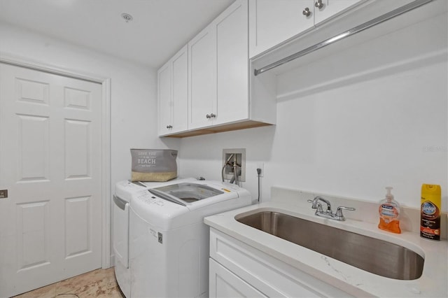 laundry area with cabinets, sink, and washing machine and clothes dryer