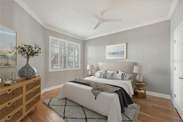 bedroom with ceiling fan, light hardwood / wood-style flooring, and crown molding