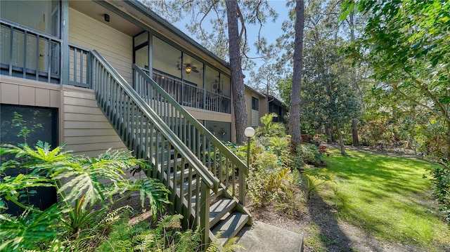 view of home's exterior featuring a yard and a sunroom