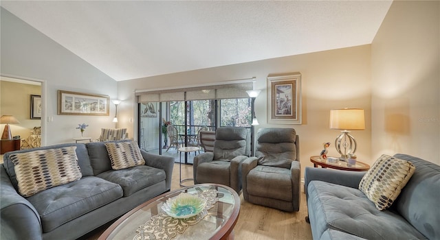 living room with light hardwood / wood-style floors and high vaulted ceiling