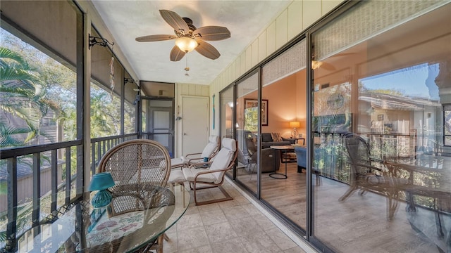 sunroom featuring ceiling fan and a wealth of natural light