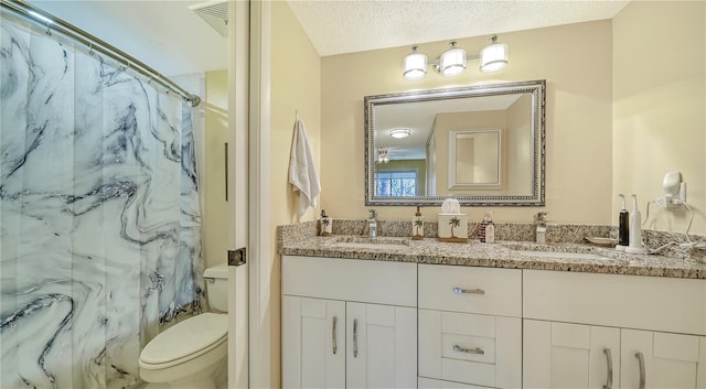 bathroom with toilet, a textured ceiling, walk in shower, and vanity