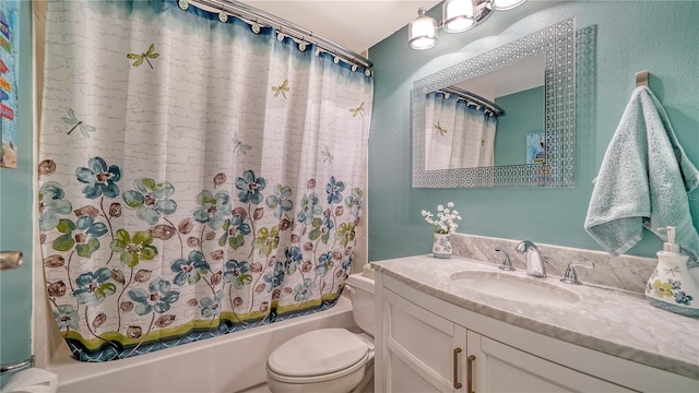 full bathroom with vanity, shower / tub combo, and toilet