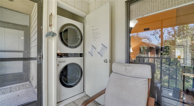 laundry room with stacked washer / dryer