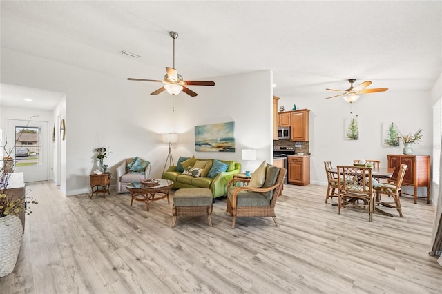 living room with light wood-type flooring and ceiling fan