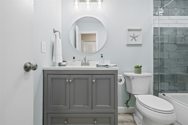 full bathroom with toilet, vanity, tiled shower / bath, and wood-type flooring